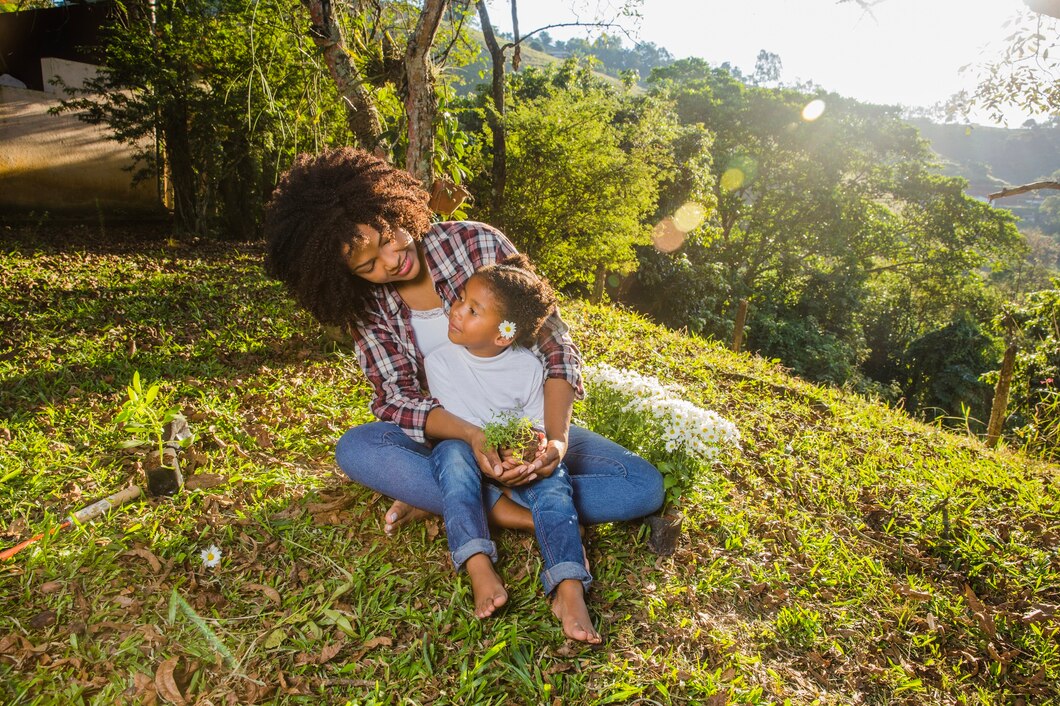 young-mother-with-daughter-sitting-hill_23-2147638916