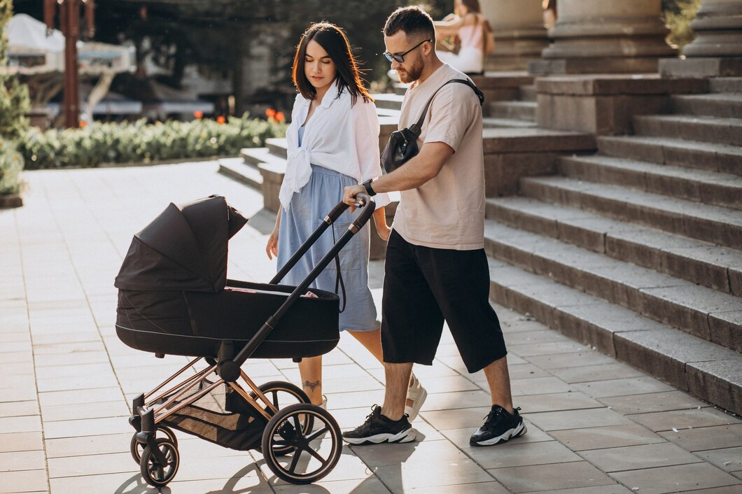 young-parents-walking-with-their-baby-stroller_1303-23688